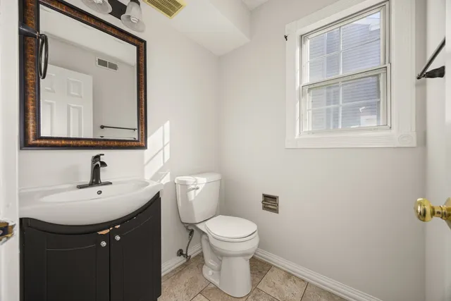 a bathroom with a sink a toilet and a mirror