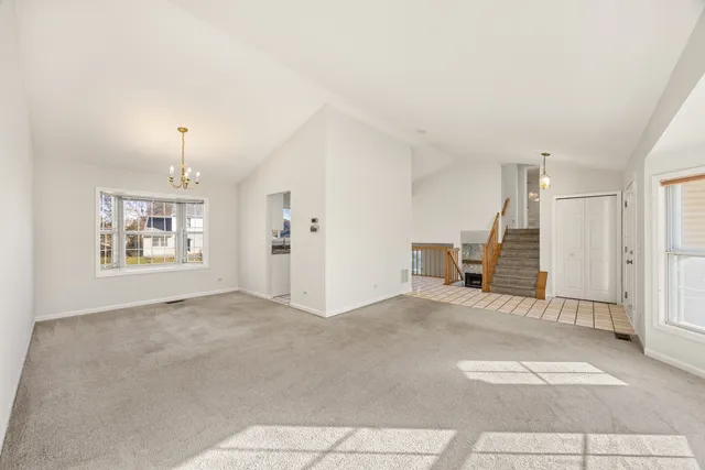 a view of a livingroom with wooden floor and a ceiling fan