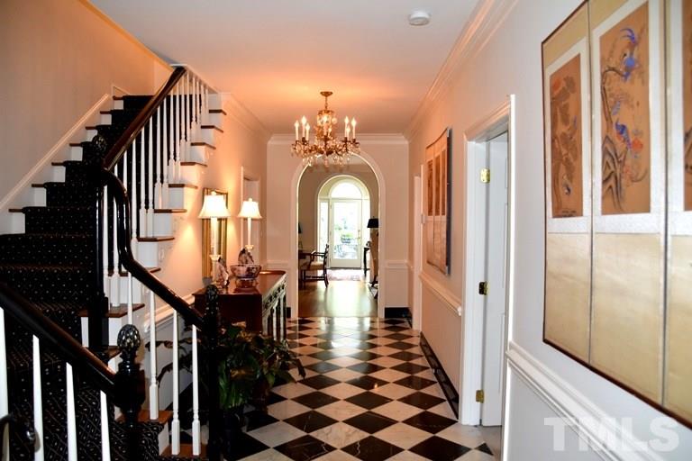 809 Lassiter Place Raleigh, NC 27609 - Photo 3 of 25 a view of a hallway with a large mirror and stairs