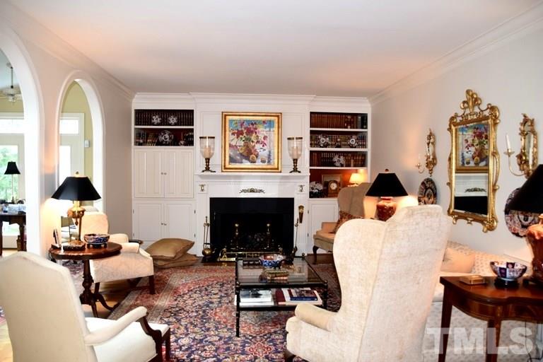 809 Lassiter Place Raleigh, NC 27609 - Photo 4 of 25 a living room with furniture a fireplace and a flat screen tv