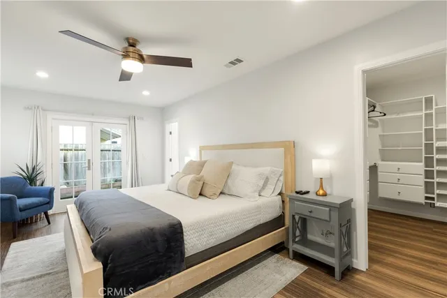 a bedroom with a bed and wooden floor