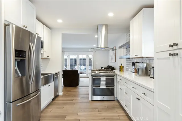 a kitchen with stainless steel appliances a refrigerator sink and stove