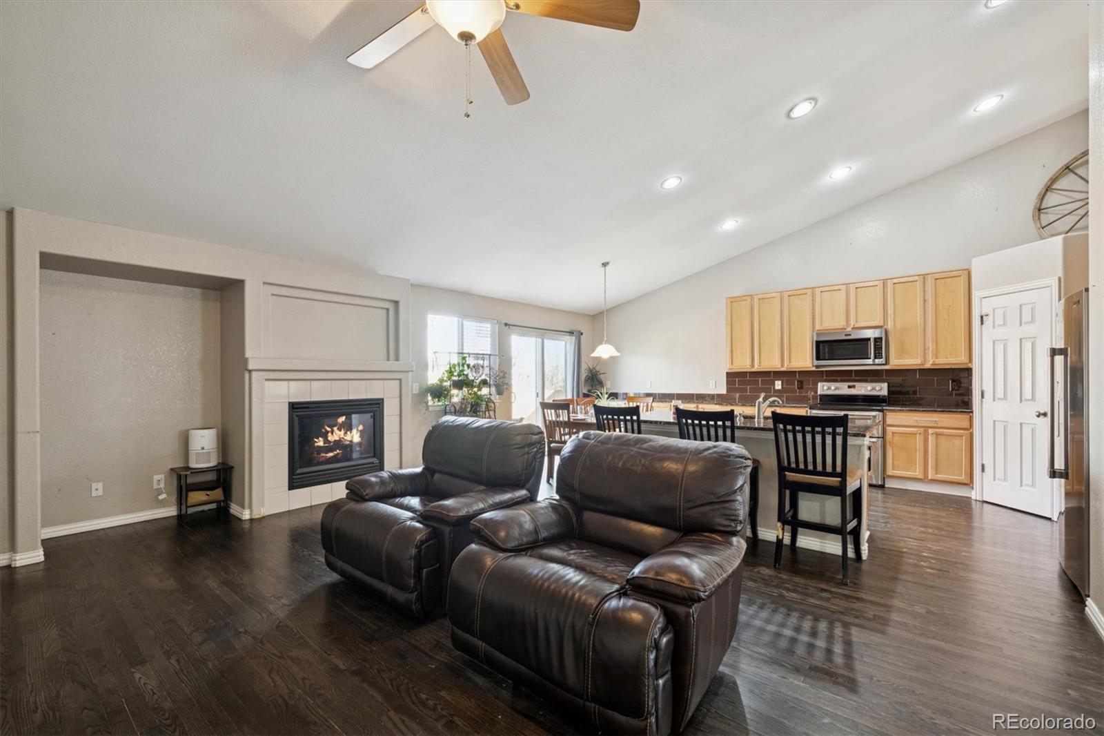 3431 Grove Street Brighton, CO 80601 - Photo 12 of 34 a living room with furniture and a fireplace