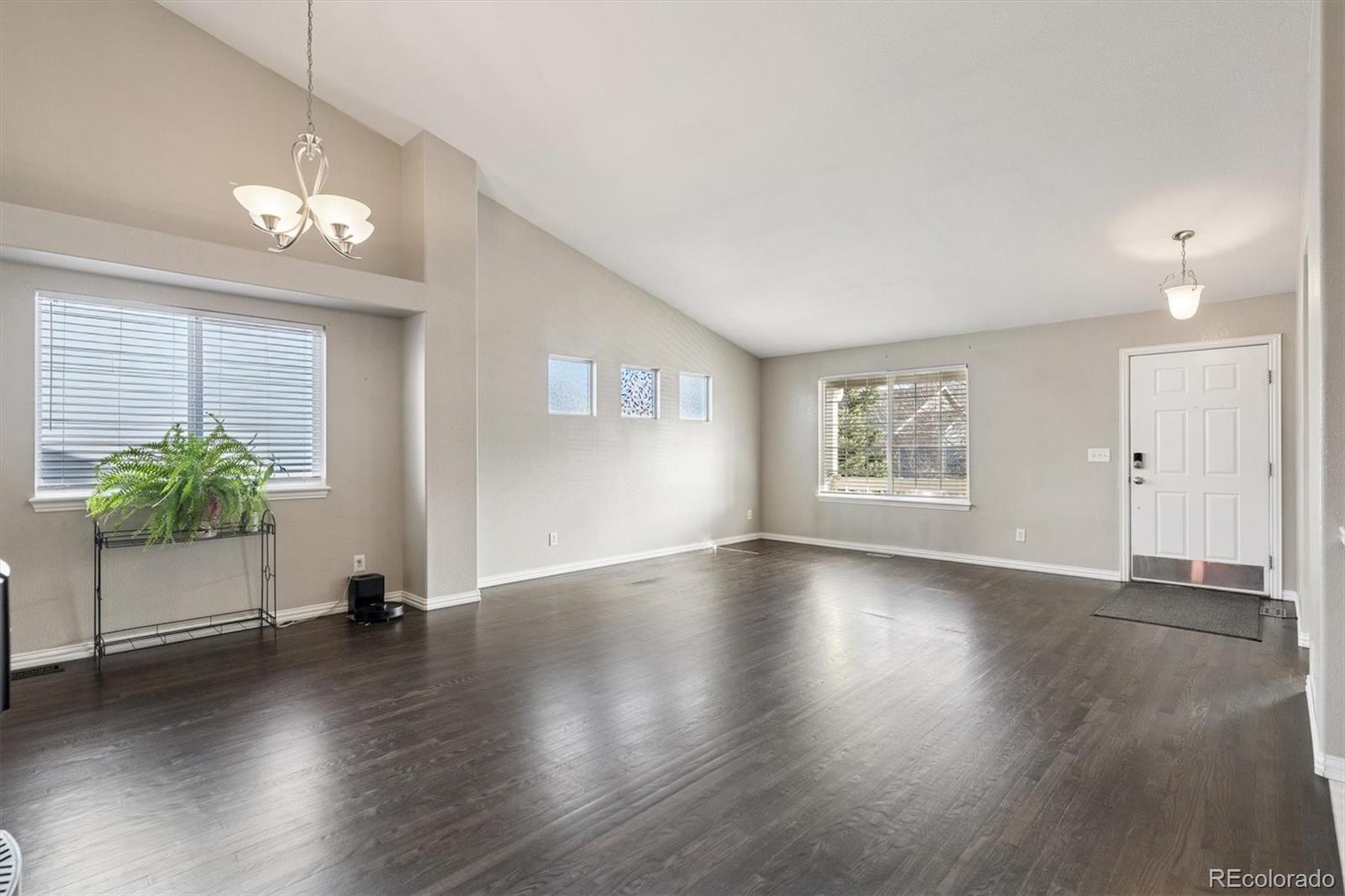 3431 Grove Street Brighton, CO 80601 - Photo 14 of 34 a view of an empty room with wooden floor and a window