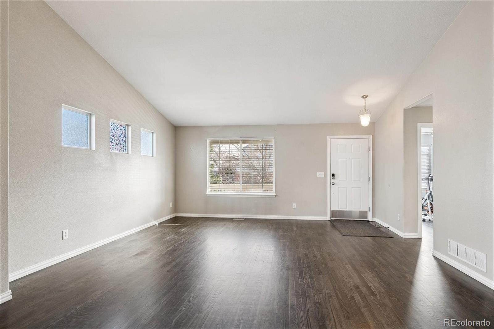 3431 Grove Street Brighton, CO 80601 - Photo 15 of 34 a view of an empty room with wooden floor and a window