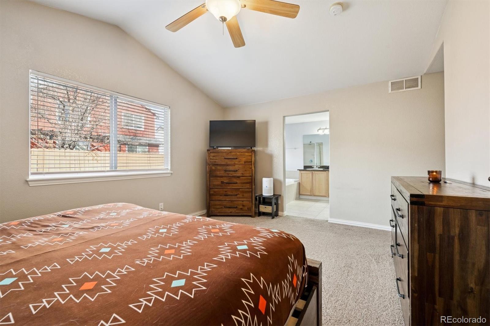 3431 Grove Street Brighton, CO 80601 - Photo 20 of 34 a bedroom with a bed and a dresser