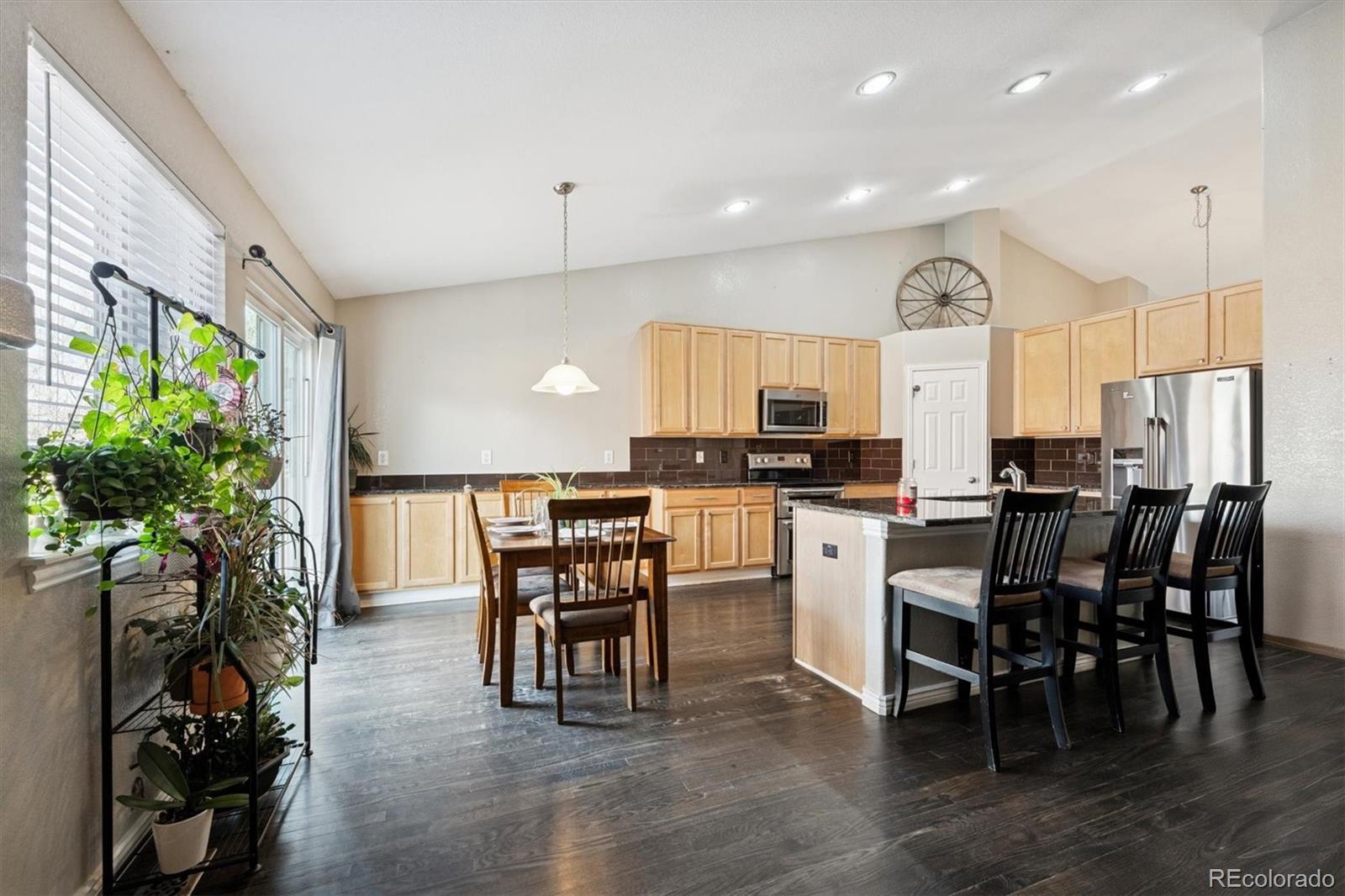 3431 Grove Street Brighton, CO 80601 - Photo 5 of 34 a view of a dining room with furniture and a potted plant