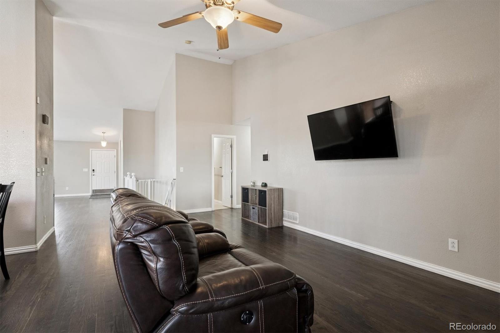 3431 Grove Street Brighton, CO 80601 - Photo 7 of 34 a living room with furniture and a flat screen tv