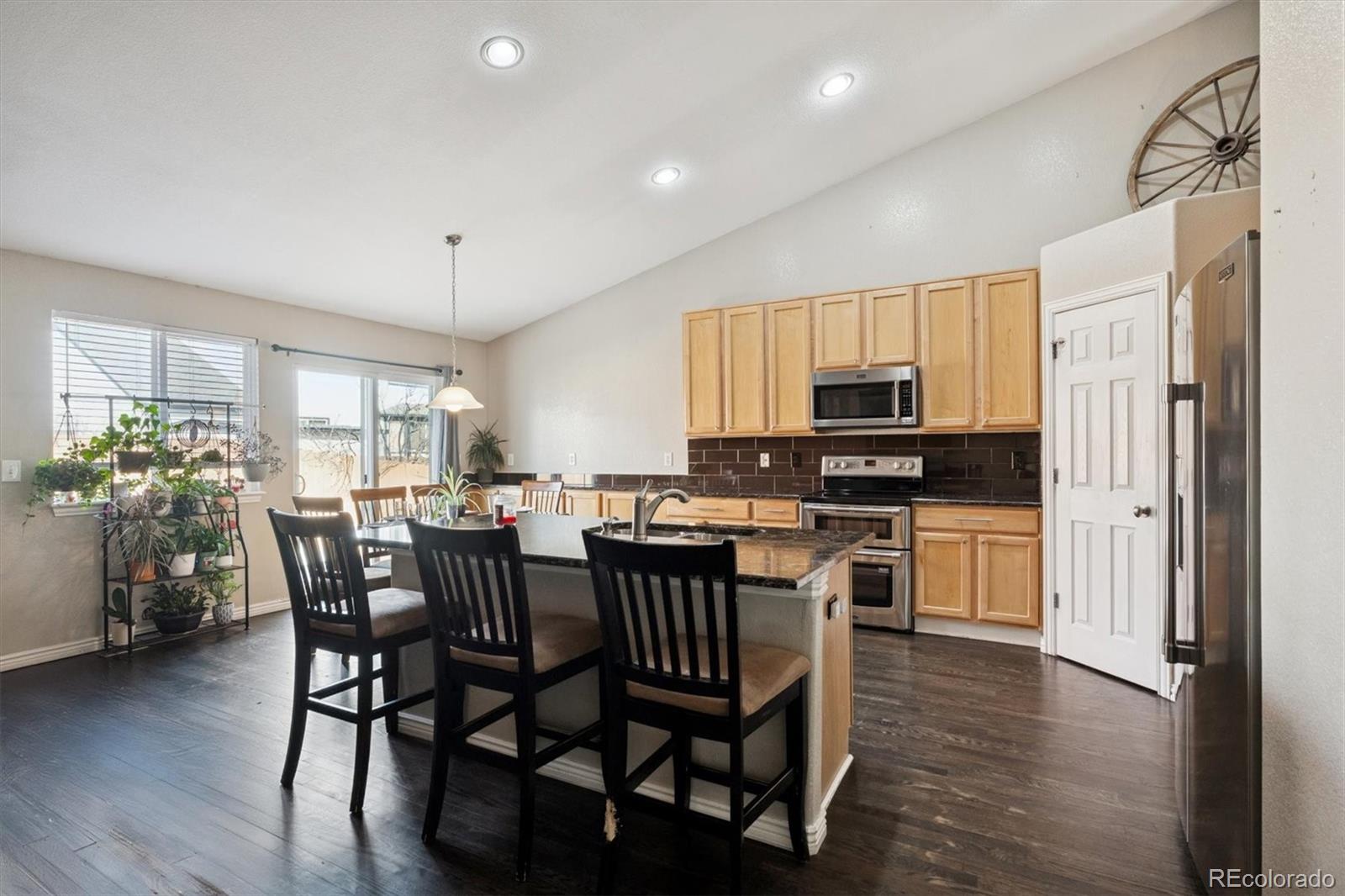 3431 Grove Street Brighton, CO 80601 - Photo 8 of 34 a view of a dining room with furniture and wooden floor