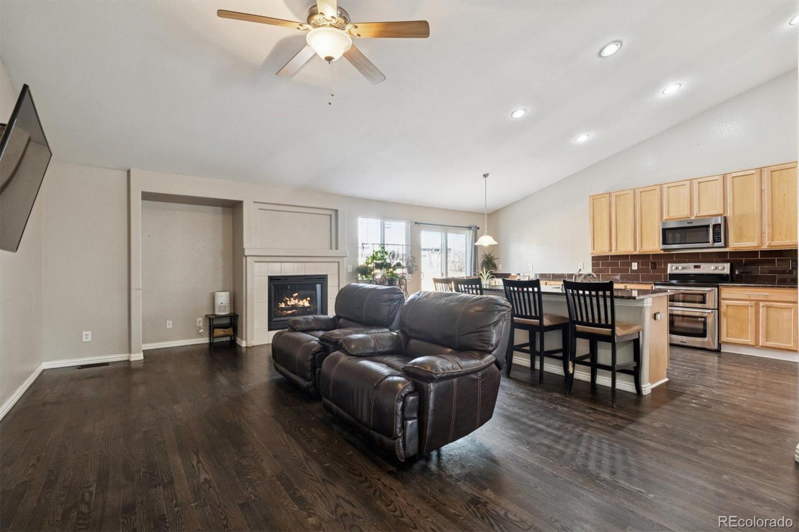 3431 Grove Street Brighton, CO 80601 - Photo 10 of 34 a living room with furniture and a fireplace