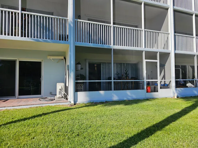 a view of a house with a yard and porch