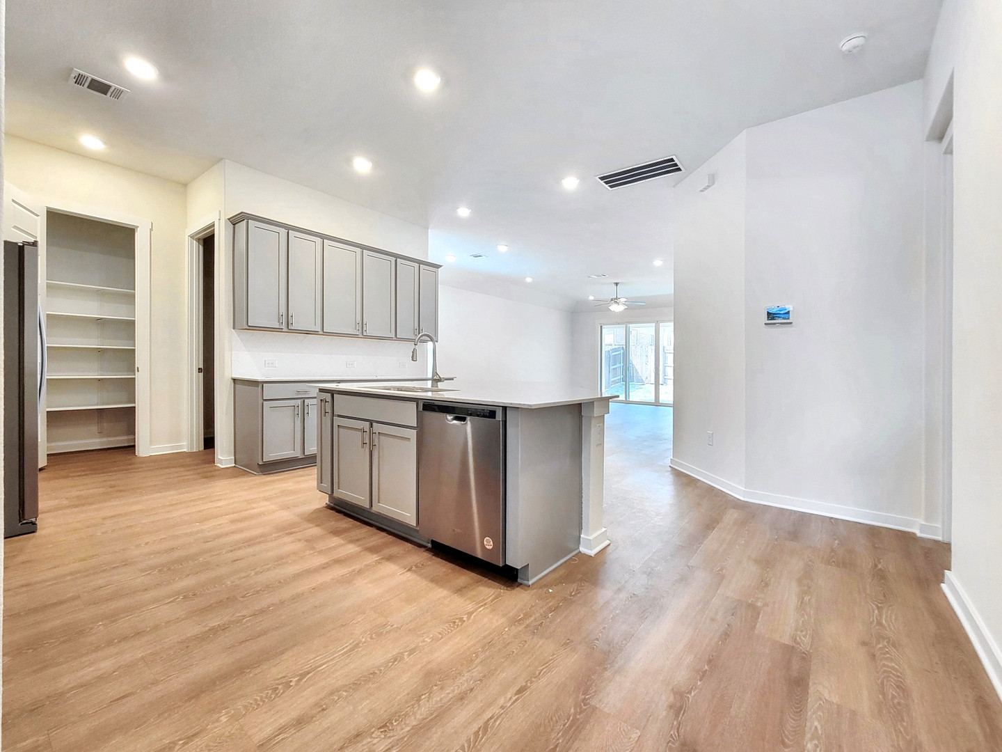 2329 Gabriels Horn Road Leander, TX 78641 - Photo 5 of 23 A contemporary kitchen island and stylish appliances flow into an open-concept living area.