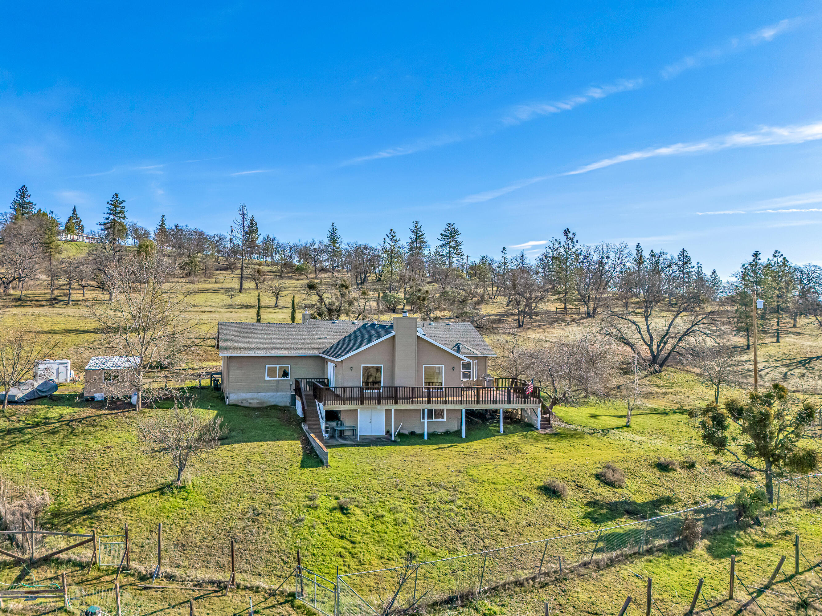 924 West Linn Road Eagle Point, OR 97524 - Photo 1 of 58 a view of a house with a big yard and large trees