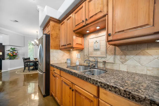 a bathroom with a granite countertop toilet sink and mirror