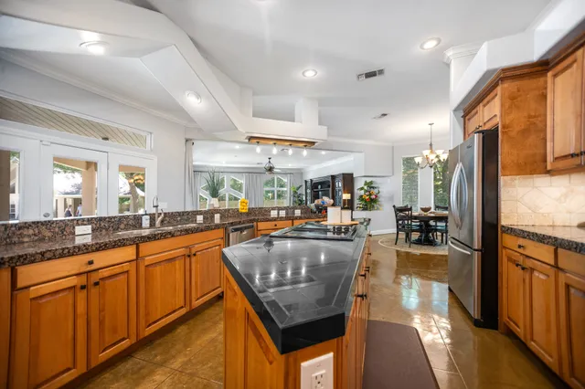 a kitchen with a sink a stove and cabinets