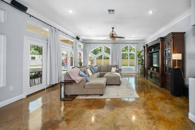 a large living room with large couches and dining area with kitchen view