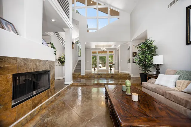 a kitchen with granite countertop counter top space a sink stainless steel appliances and windows