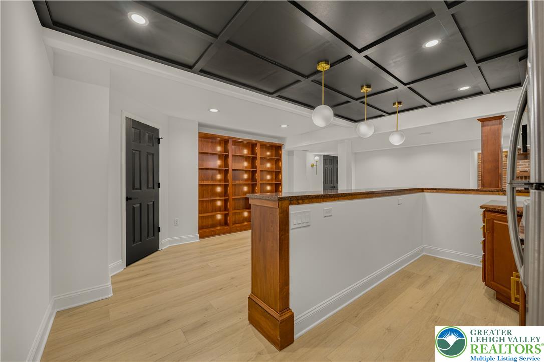 3130 Muirfield Road Center Valley, PA 18034 - Photo 44 of 63 An elegant coffered ceiling and built-in bookcases highlight this open lower-level living area.