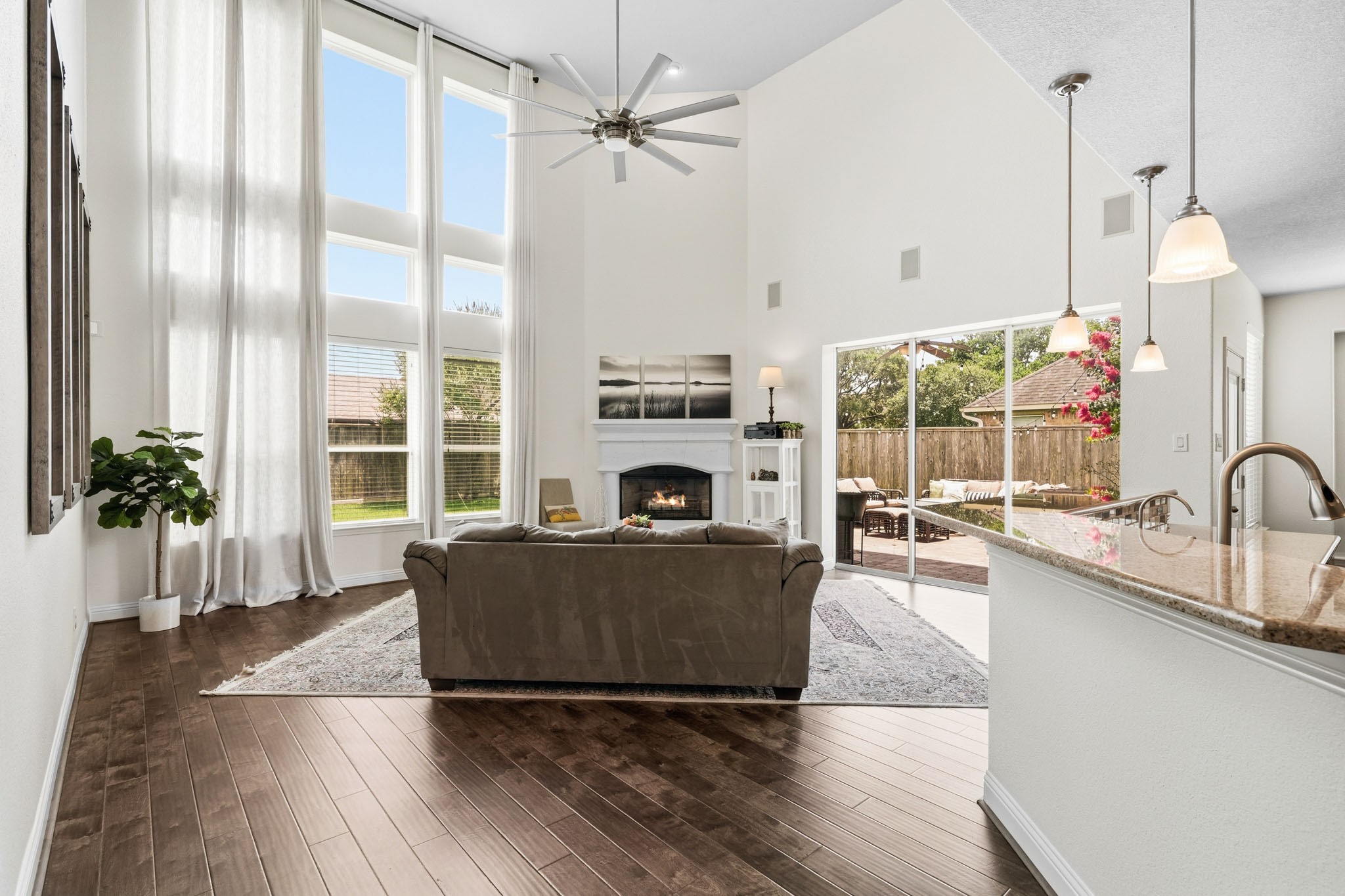 17610 Strackfield Lane Tomball, TX 77377 - Photo 8 of 50 Soaring two-story ceilings, rich hardwood floors and a dramatic wall of windows dressed with blinds and drapes create a stunning gathering space filled with natural light.