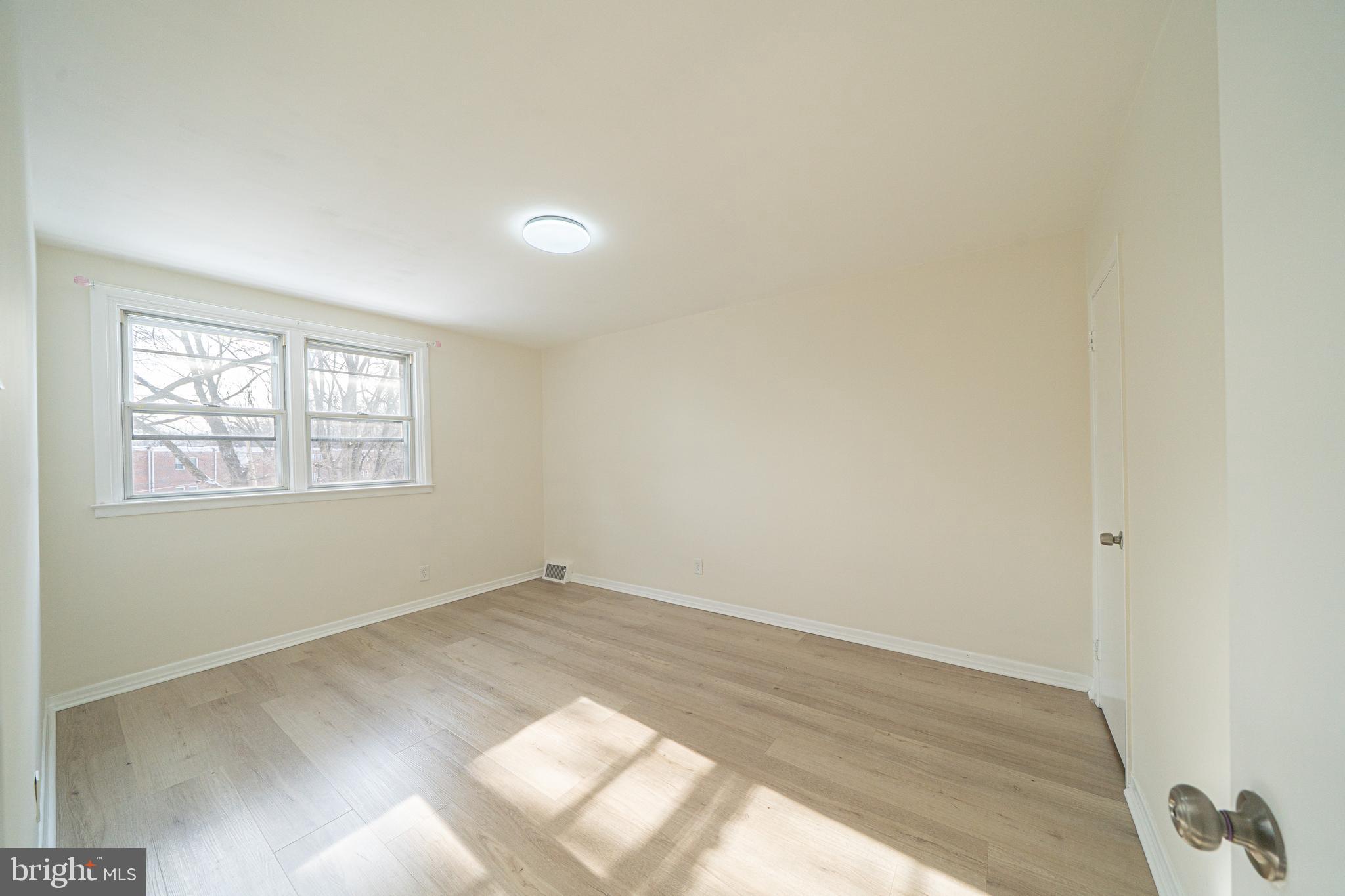 3674 Salina Road Philadelphia, PA 19154 - Photo 12 of 22 an empty room with wooden floor and windows
