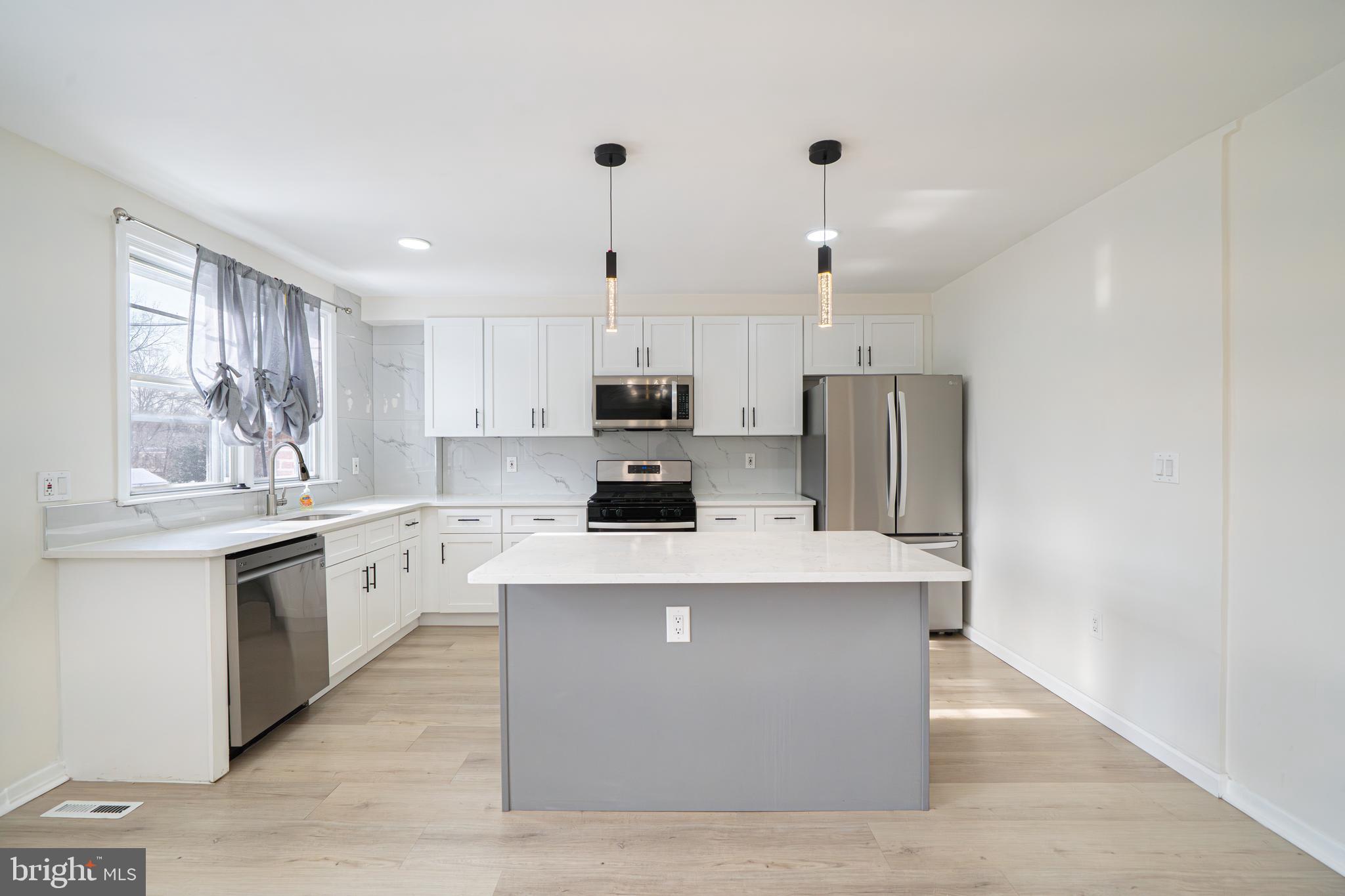 3674 Salina Road Philadelphia, PA 19154 - Photo 7 of 22 a kitchen with stainless steel appliances white cabinets a sink a stove a refrigerator and a oven