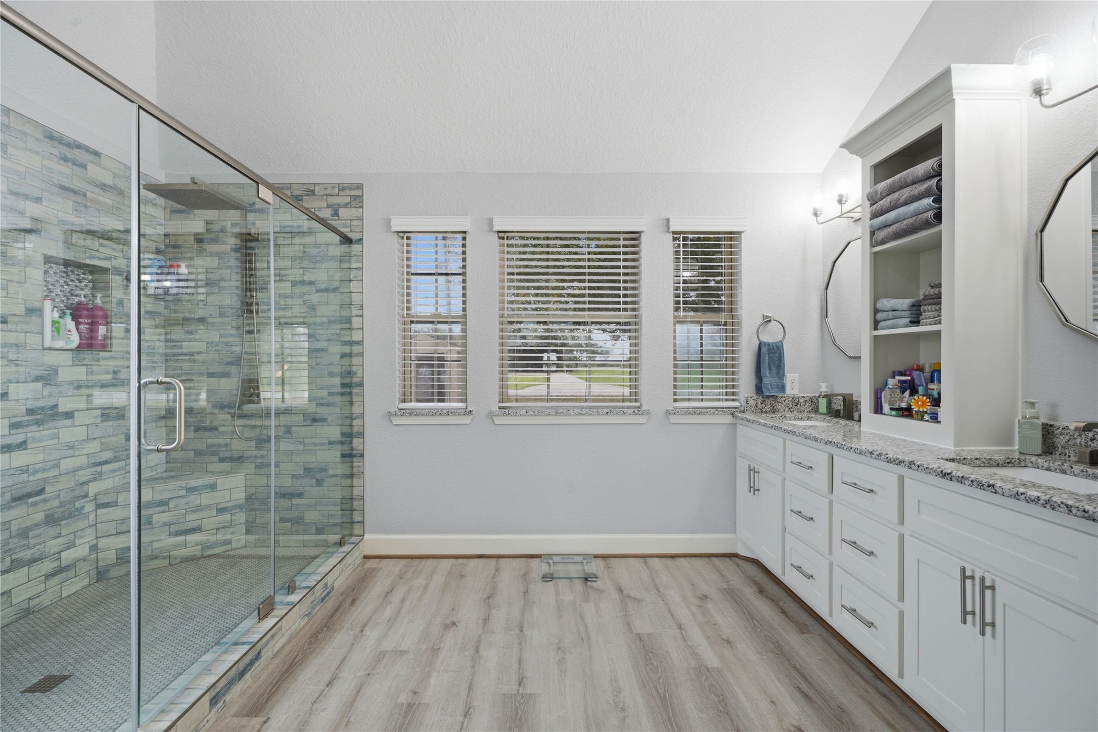 615 Lilley Road Alvin, TX 77511 - Photo 17 of 42 Master bathroom upgrades include dual sinks, granite counters, custom en-suite walk-in his/hers showers with glass surrounds, rain shower head, and two benches.