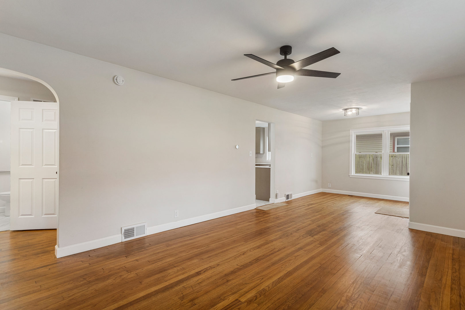 807 South Hamilton Street Monticello, IL 61856 - Photo 13 of 39 a view of an empty room with wooden floor
