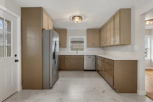 a kitchen with a cabinets and a refrigerator