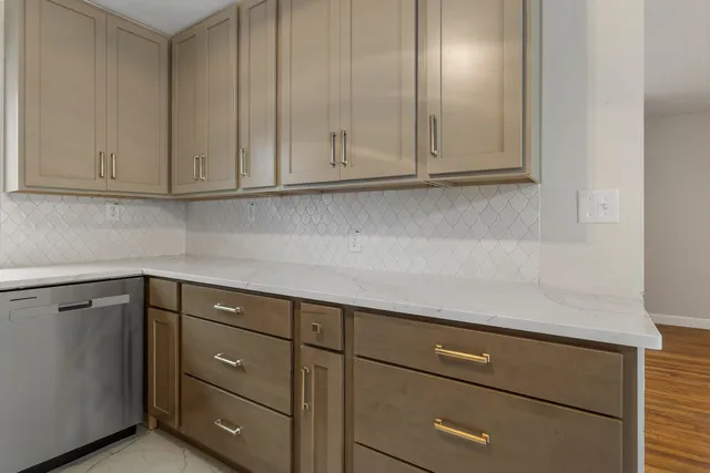 a kitchen with cabinets and white appliances