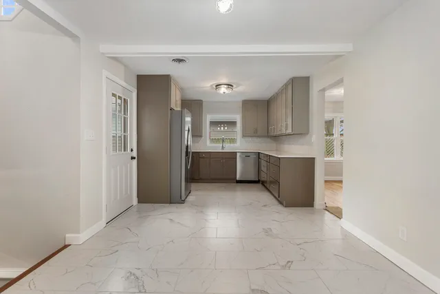 a view of a kitchen with an empty space and a window