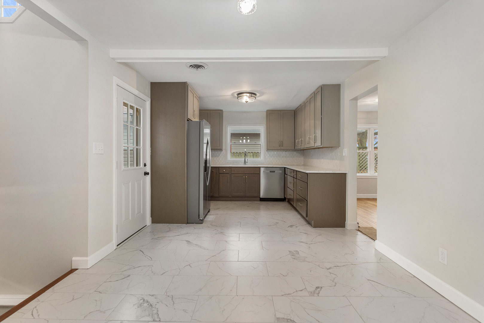 807 South Hamilton Street Monticello, IL 61856 - Photo 19 of 39 a view of a kitchen with an empty space and a window