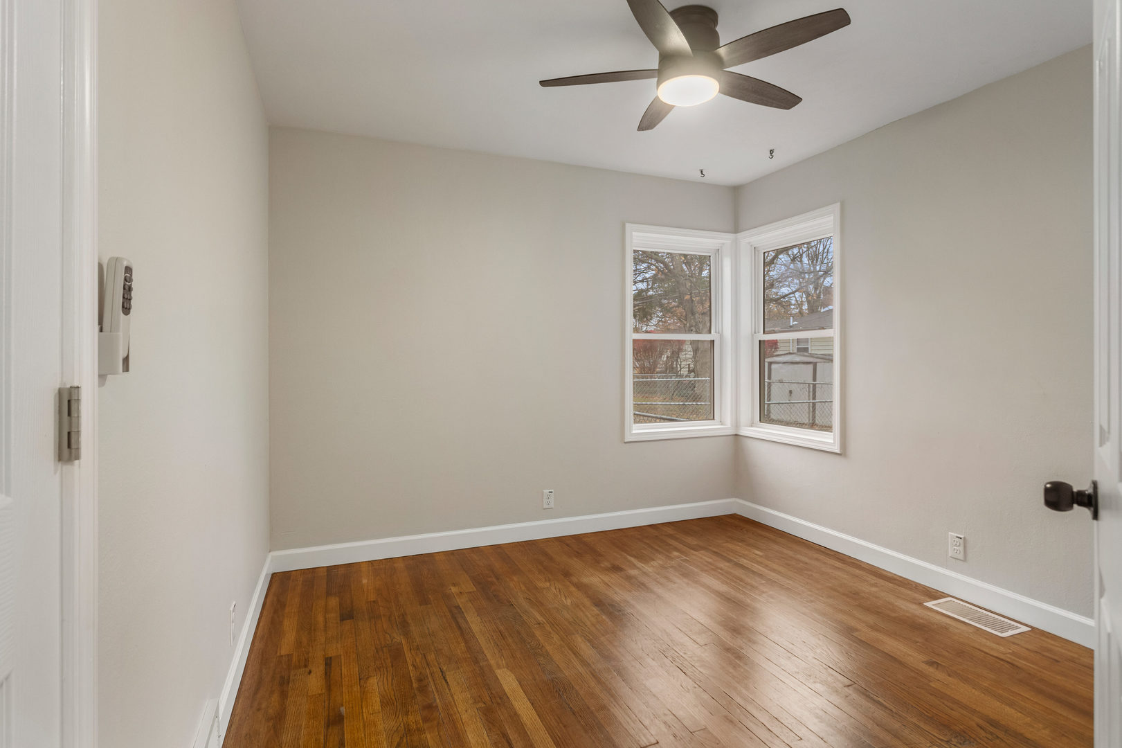 807 South Hamilton Street Monticello, IL 61856 - Photo 21 of 39 wooden floor in an empty room with a window