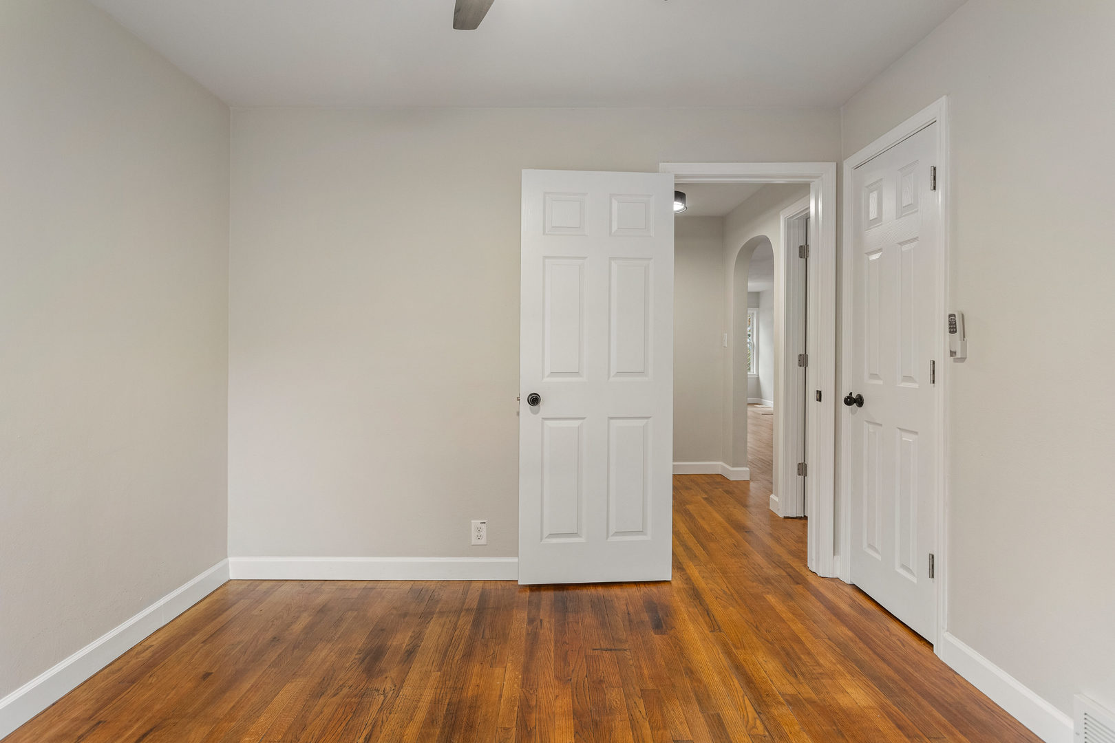 807 South Hamilton Street Monticello, IL 61856 - Photo 22 of 39 a view of a hallway with wooden floor and a bathroom