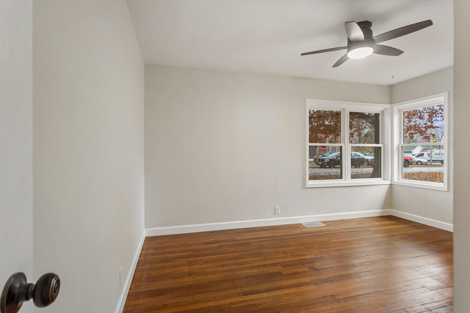 807 South Hamilton Street Monticello, IL 61856 - Photo 24 of 39 a view of an empty room with window and wooden floor