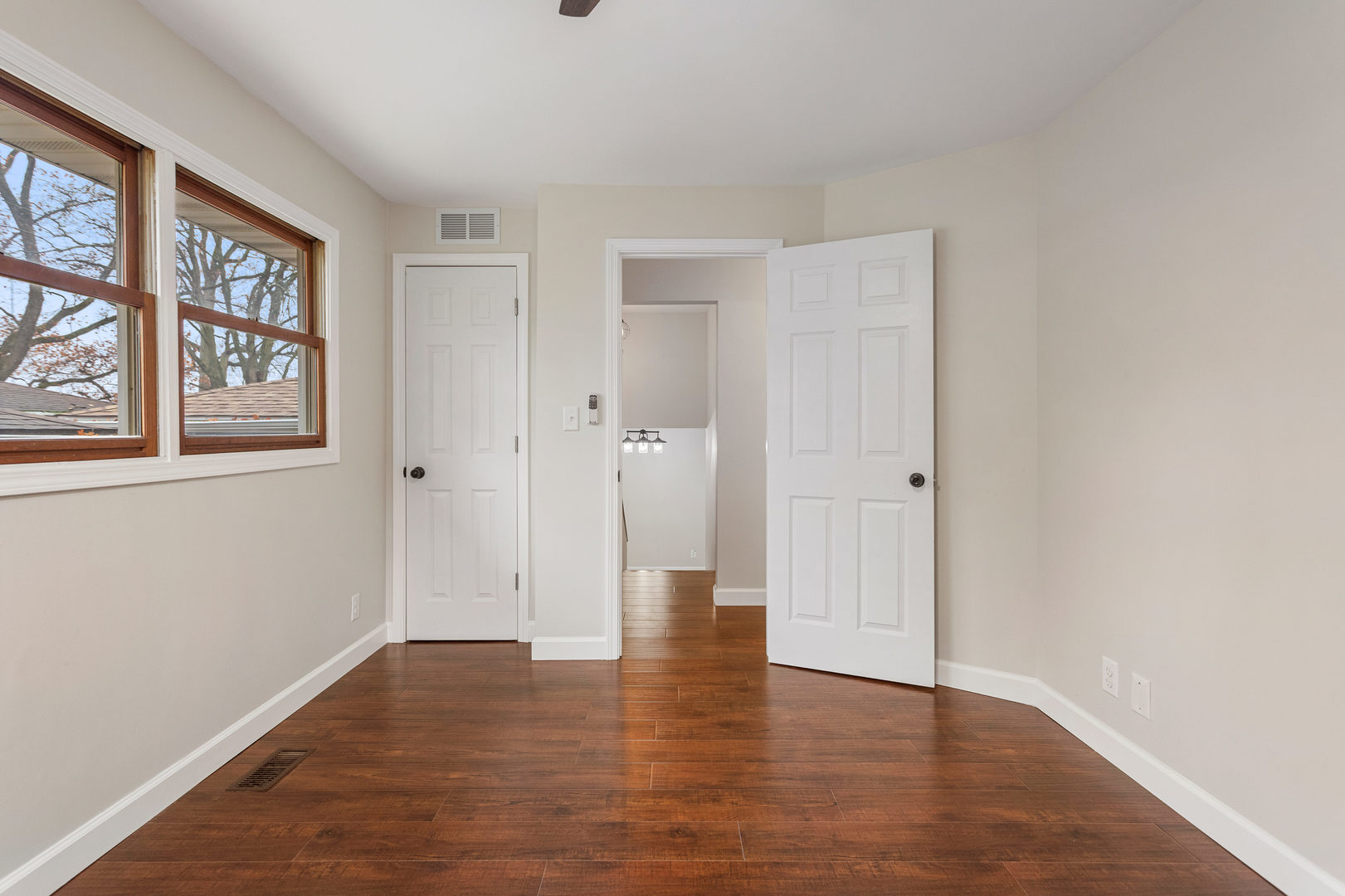 807 South Hamilton Street Monticello, IL 61856 - Photo 31 of 39 a view of an empty room with wooden floor and windows