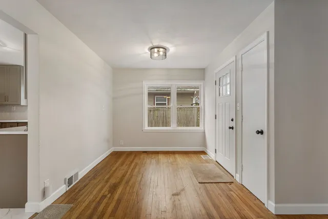 a view of wooden floor in a room with a window