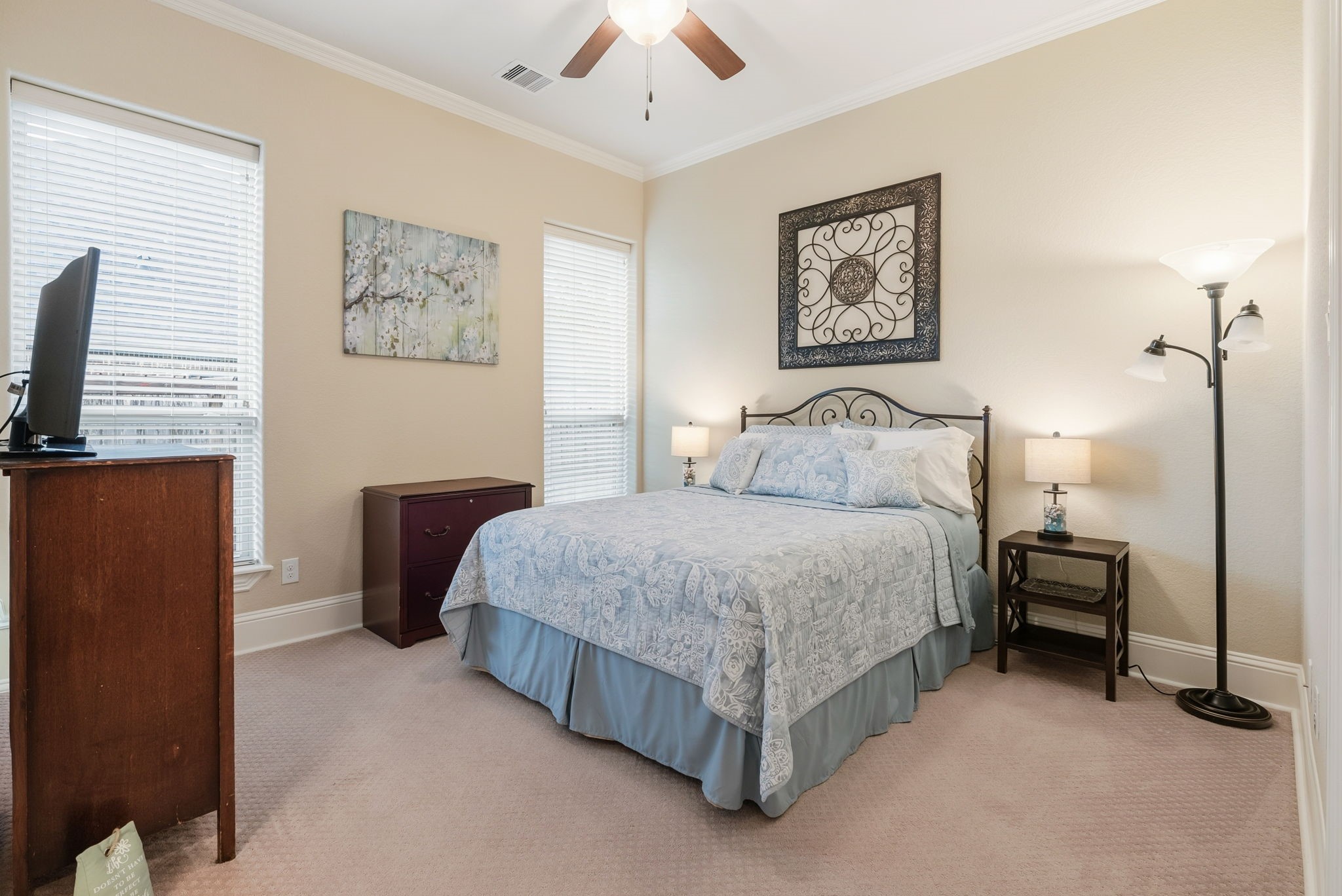 28502 Crawford Ridge Court Huffman, TX 77336 - Photo 30 of 50 a bedroom with a bed a wall painting and a lamp