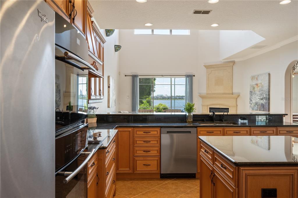 8119 Vía Rosa Orlando, FL 32836 - Photo 15 of 62 a kitchen with granite countertop a sink stove and cabinets