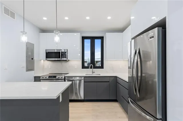 a kitchen with a sink and a microwave