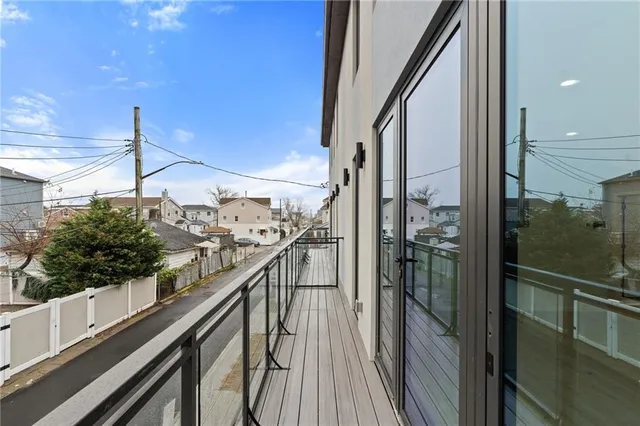 a view of a balcony with wooden floor and fence