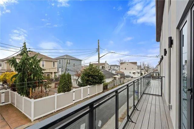 a view of a balcony with wooden floor and iron stairs