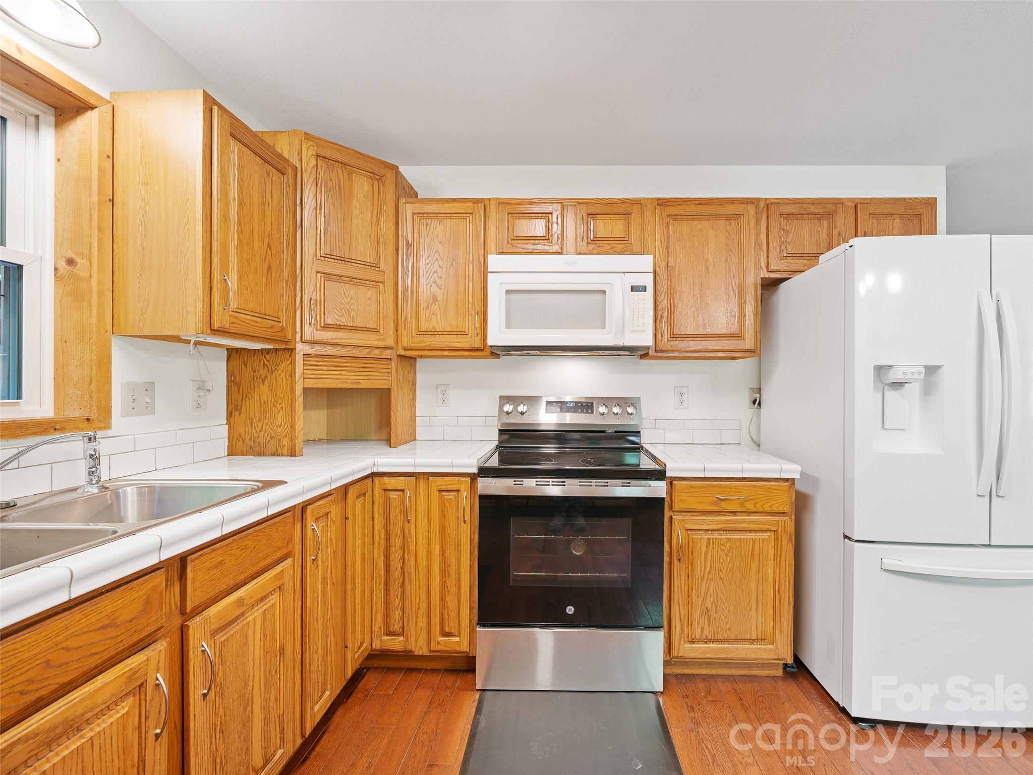 142 Wildflower Road Spruce Pine, NC 28777 - Photo 9 of 46 a kitchen with a sink a stove and refrigerator