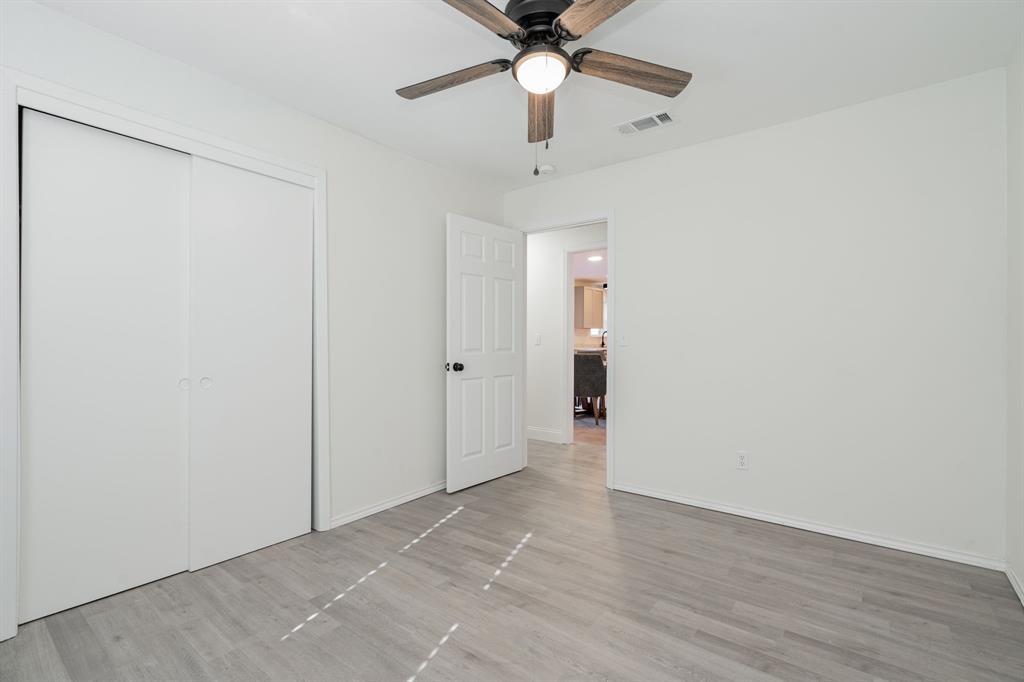 508 Rogers Way Rockwall, TX 75087 - Photo 17 of 25 wooden floor in an empty room with a chandelier fan