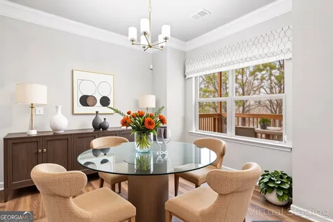 a dining room with furniture and window