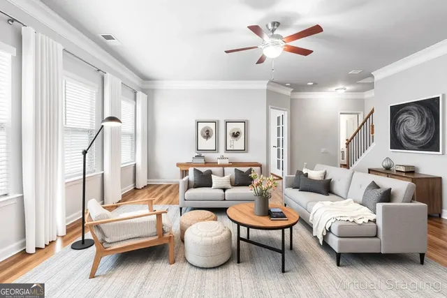 a living room with furniture a ceiling fan and a rug