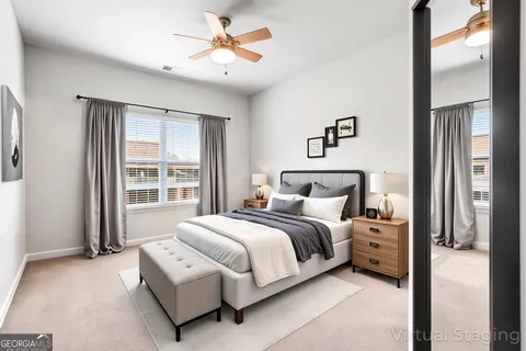 a bedroom with a large bed and a chandelier