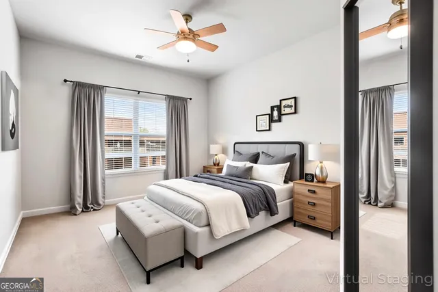 a bedroom with a large bed and a chandelier