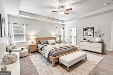 a spacious bedroom with a bed and window