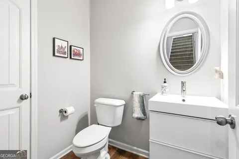 a bathroom with a toilet a sink and mirror