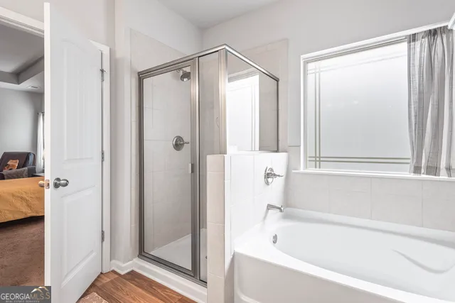 a bathroom with a bathtub and a shower